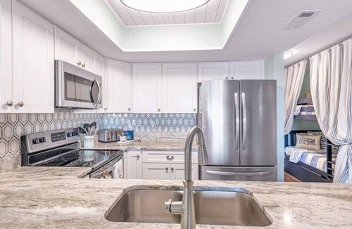Surf City Condo | Beautifully decorated condo with view of the pool and ocean in perfect location.