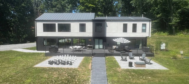 Experience elevated living in a magnificent brand new modern home set on 5 acres in Clinton Corners