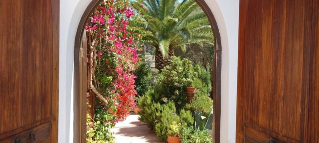 Relaxation in Mediterranean garden landscape at the large private pool in S'Arracó